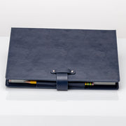 Faux Leather TTRPG book cover in navy blue with buckle towards camera.
