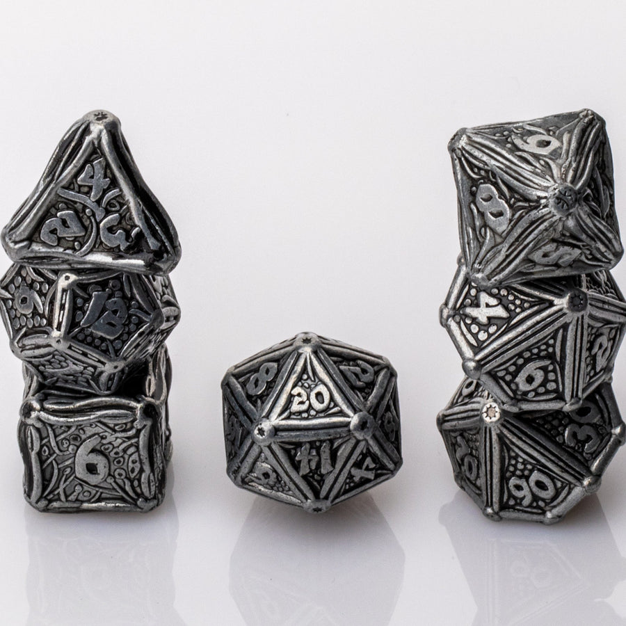 Ancient Iron, scrolled metal 7 piece RPG Dice Set stacked on a white background.