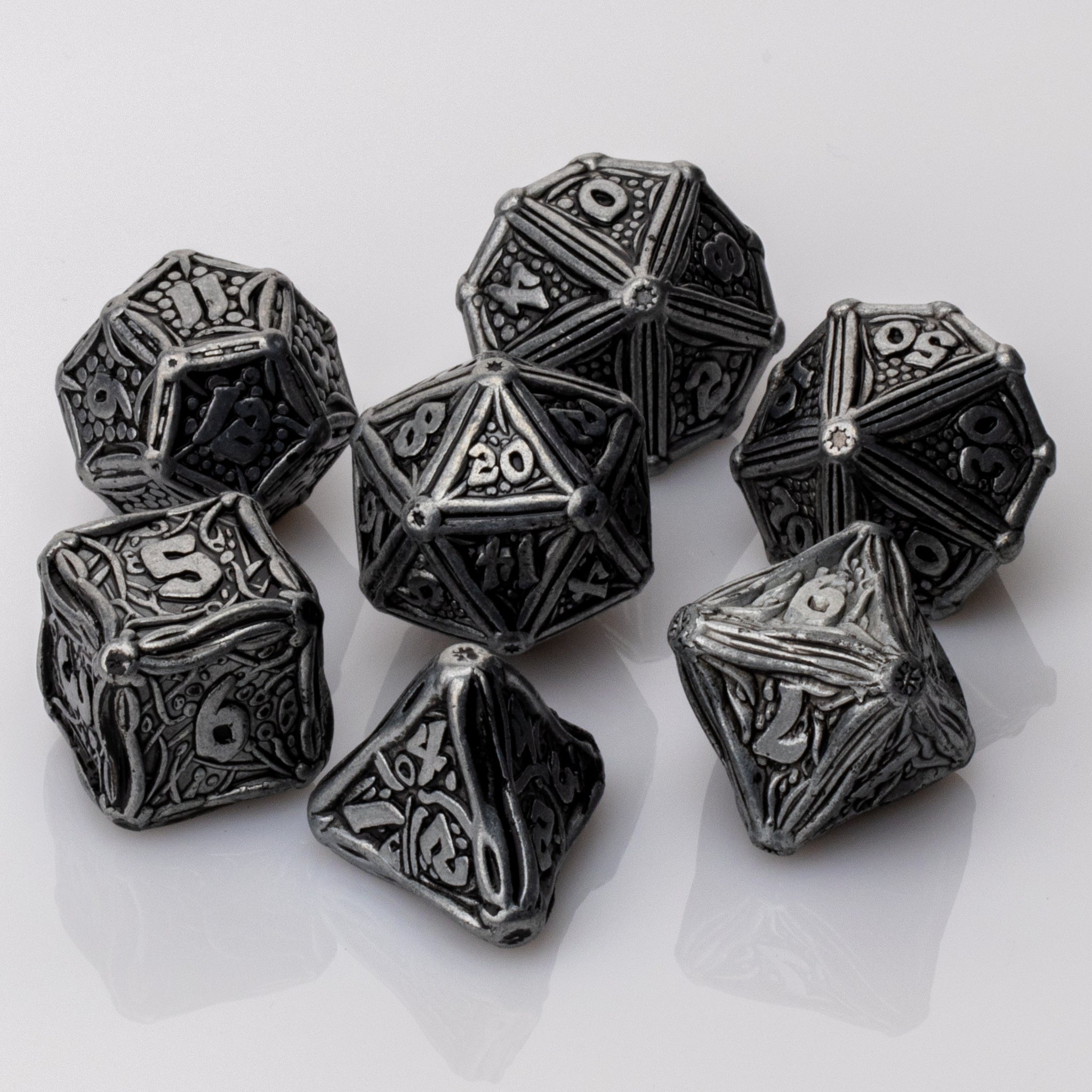Ancient Iron, scrolled metal 7 piece RPG Dice Set on a white background.