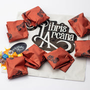 Libris Arcana Dice Addict Subscription, 7 full sets of dice, 7 random dice, and packaging laid out on a white background.