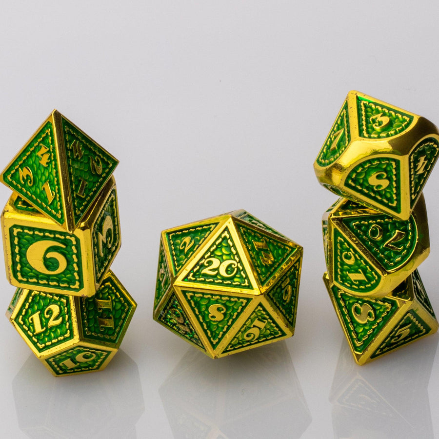 Dragon Scale, green and gold metal DND dice set stacked on a white background.