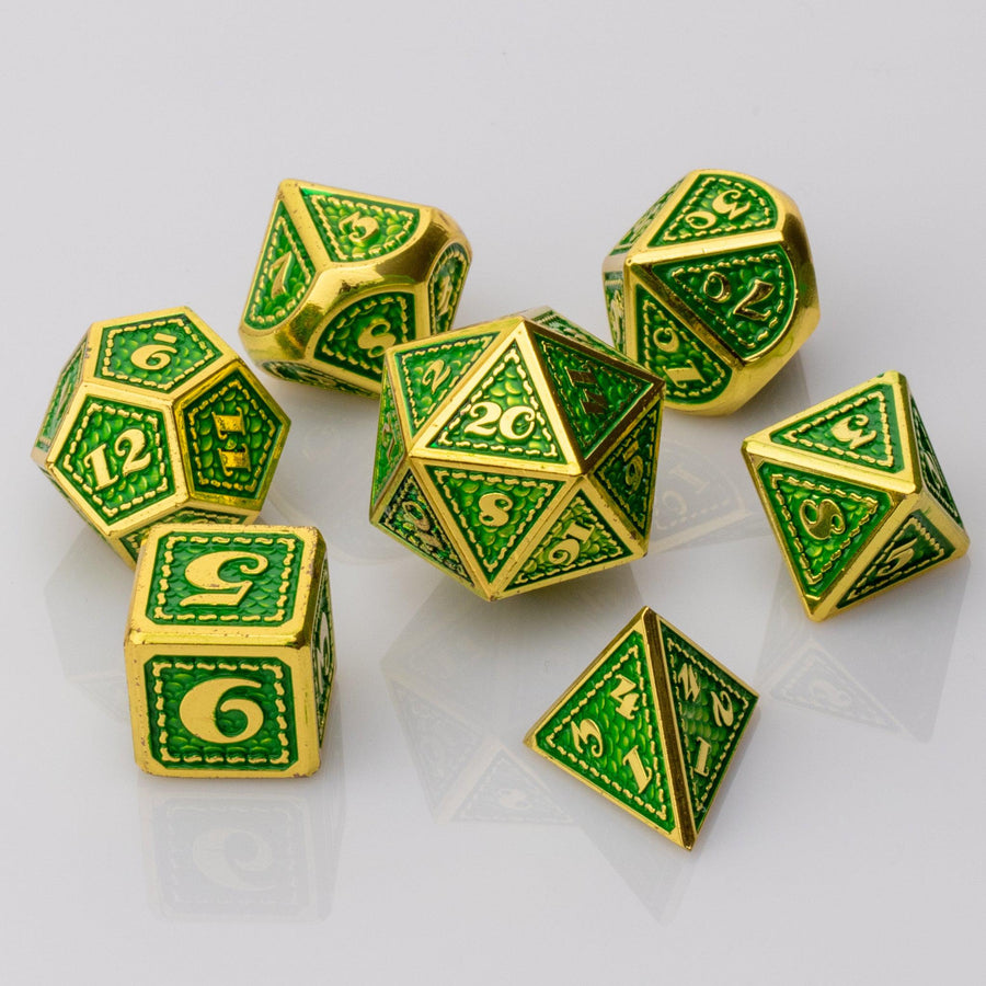 Dragon Scale, green and gold metal DND dice set on a white background.