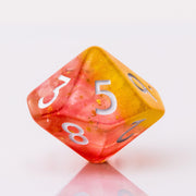 Dreamsicle, rose gold and orange d10 on a white background.