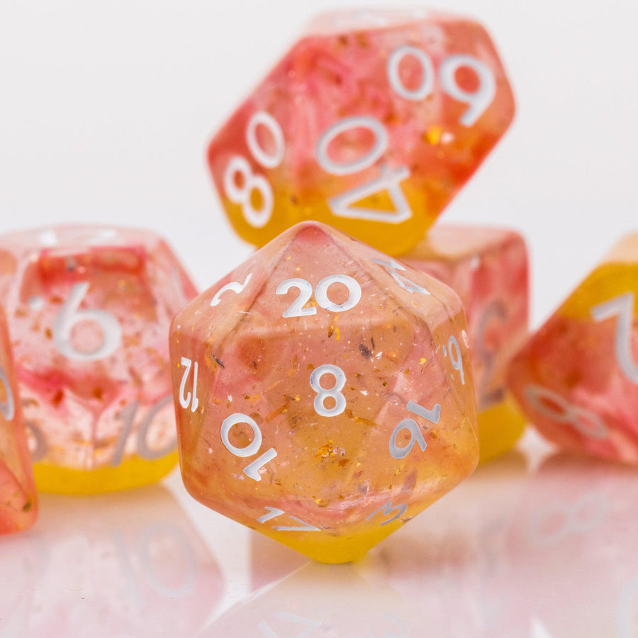Dreamsicle, closeup of rose gold and orange dnd dice set on a white background.