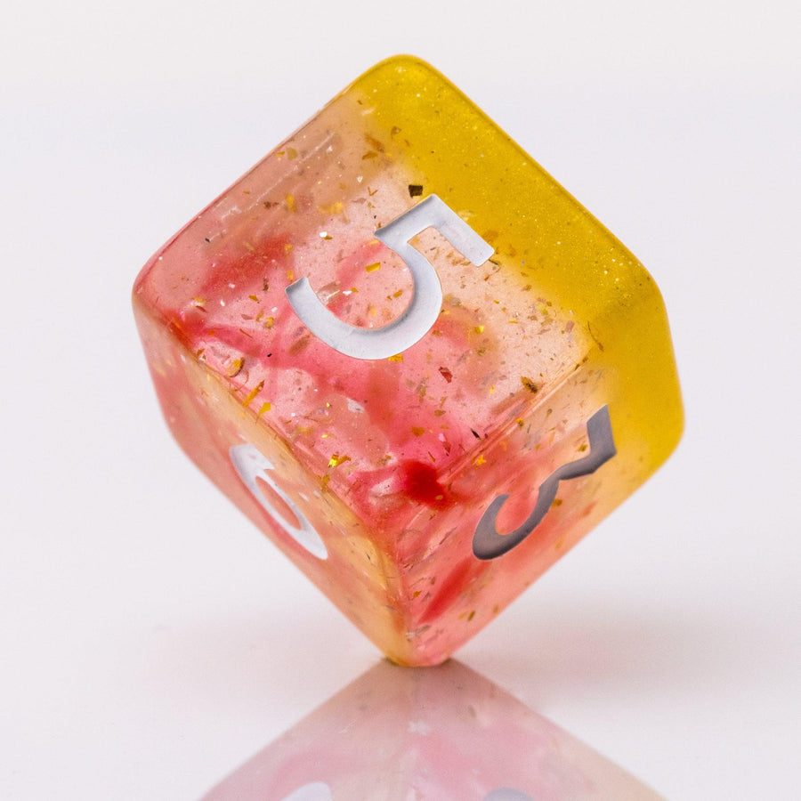 Dreamsicle, rose gold and orange d6 on a white background.