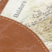 Faux Leather TTRPG book cover in natural brown, closeup on inner stitching.