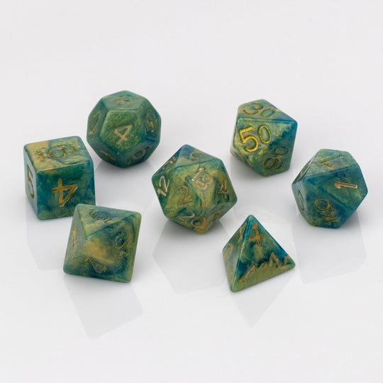 Genesis, green and gold 7 piece resin RPG dice set on white background.
