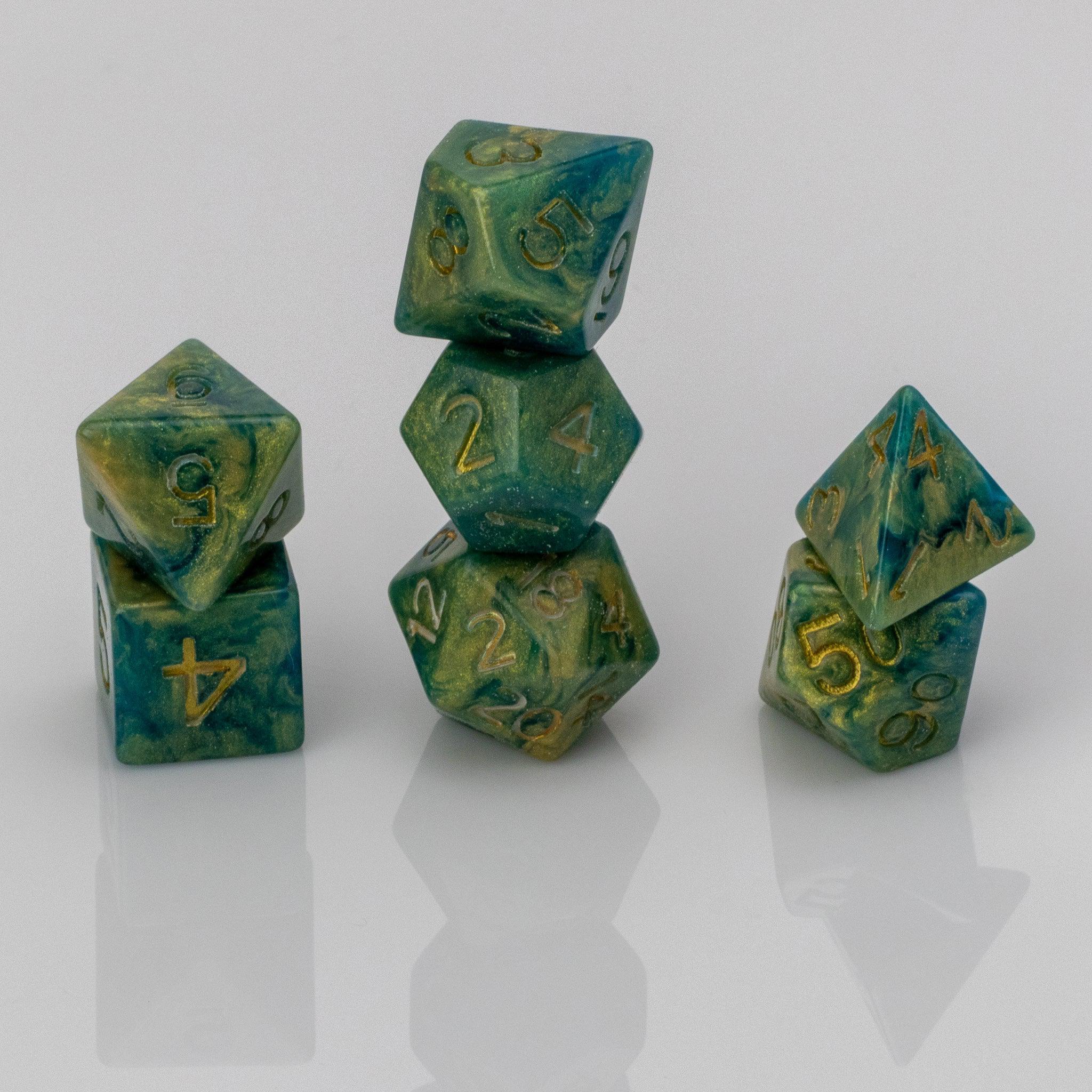 Genesis, green and gold 7 piece resin RPG dice set stacked on white background.