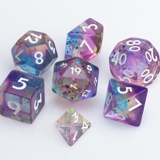 Sakura Sunset, translucent blue and purple 7 piece resin RPG dice set on white background.