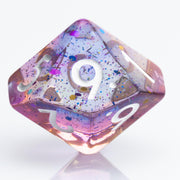Sakura Sunset, translucent blue and purple 7 piece resin RPG dice set D10 on white background.