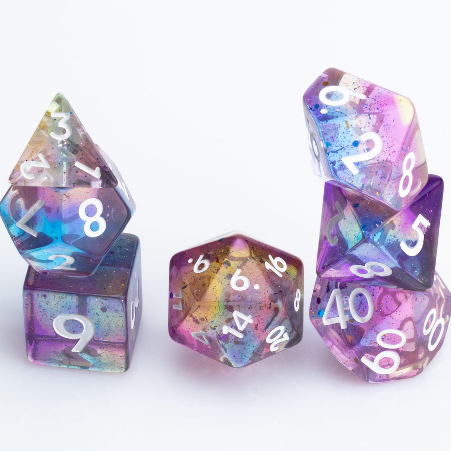 Sakura Sunset, translucent blue and purple 7 piece resin RPG dice set stacked on white background.