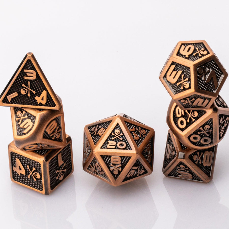 Skullsmash, Copper colored metal RPG dice set with skull and crossbones stacked on a white background.