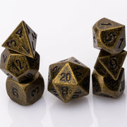 Thunk, weathered bronze colored metal DND dice set stacked on a white background.
