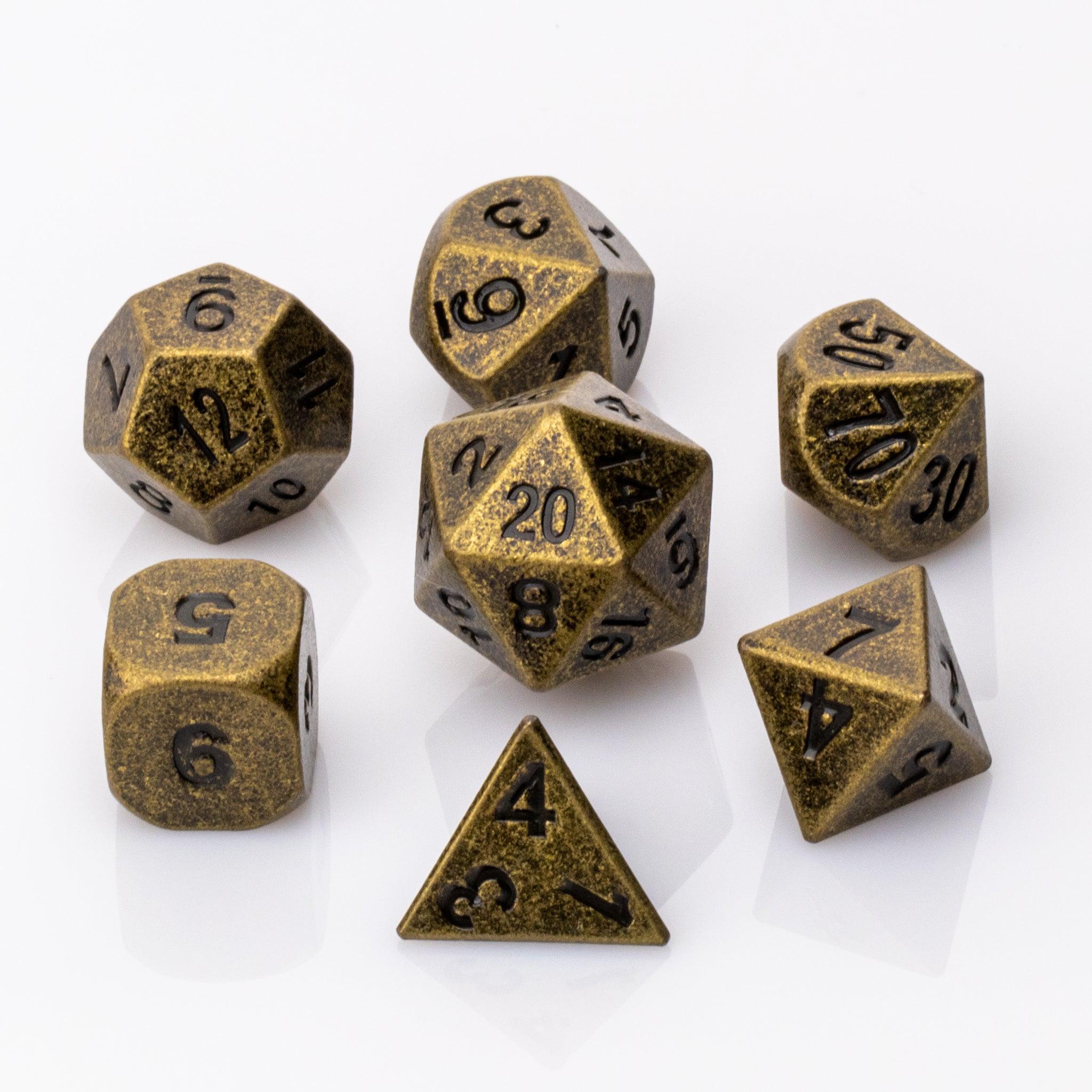 Thunk, weathered bronze colored metal DND dice set on a white background.