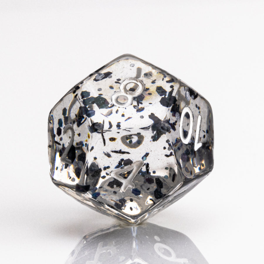 Upside Down, crystal clear 7 piece DND dice set with dark floating inclusions D12 on white background.