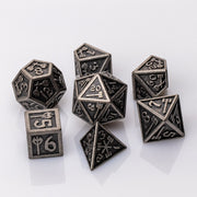 Weapon Rack, nude metal RPG dice set adorned with weaponry on a white background.