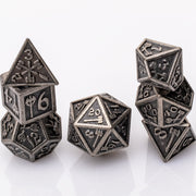 Weapon Rack, nude metal RPG dice set adorned with weaponry stacked on a white background.