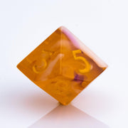 Autumn Spirit, trunslucent orange resin with swriling lavender and opaque cream. 7 piece RPG dice set D10 on white background.