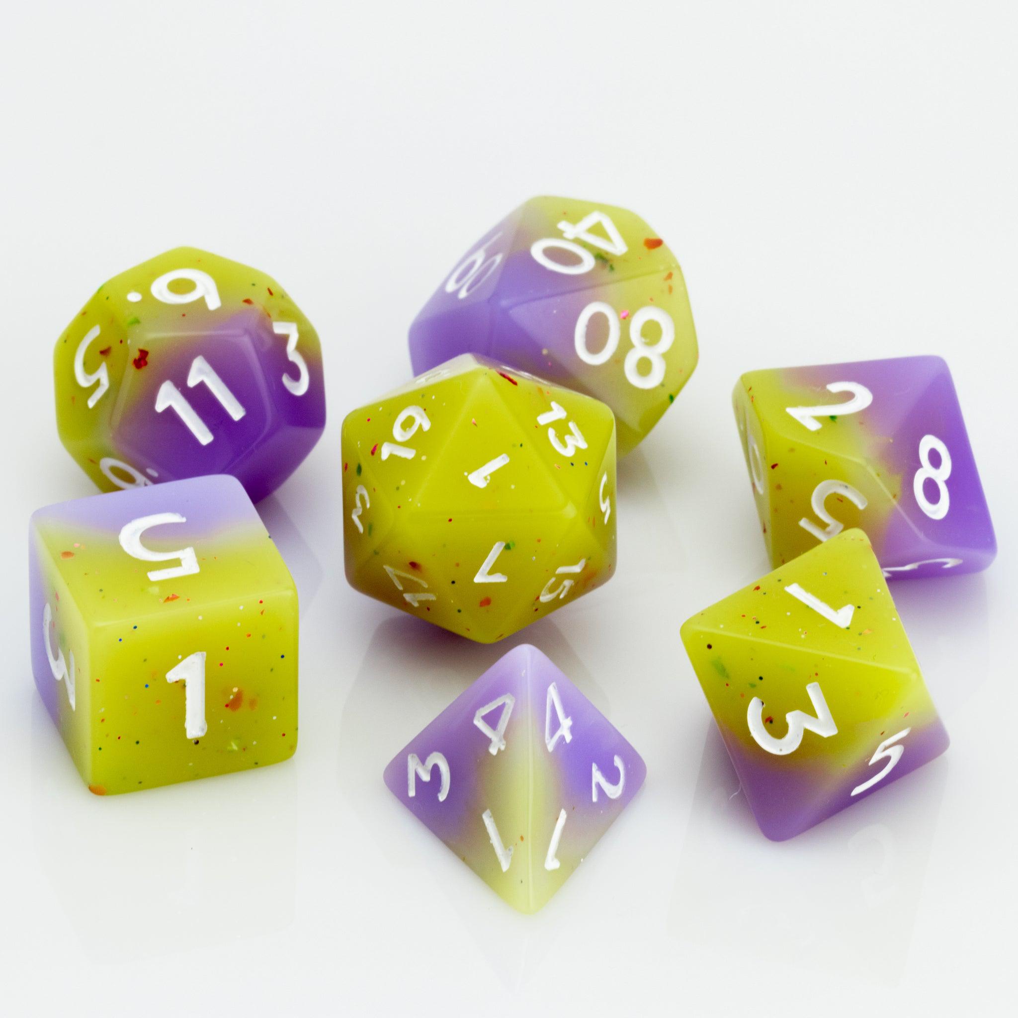 Cupcakes yellow & purple 7 piece RPG dice set on a white background.