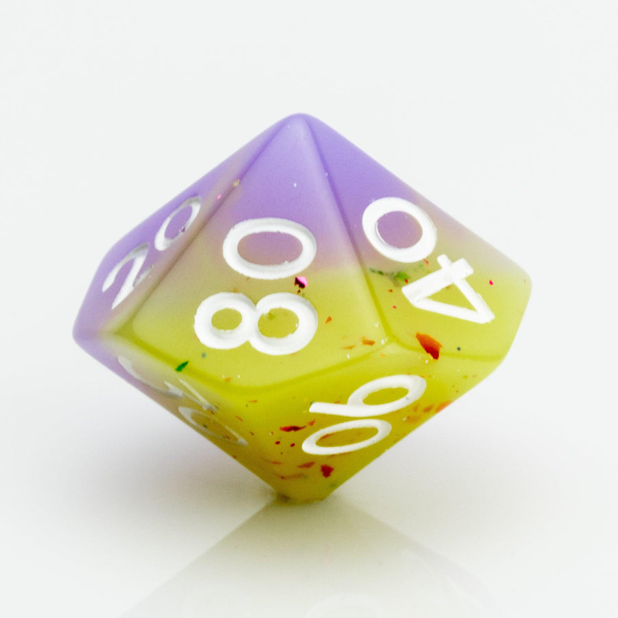 Cupcakes yellow & purple 7 piece RPG dice set D00 on a white background.