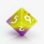 Cupcakes yellow & purple 7 piece RPG dice set D10 on a white background.