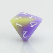 Cupcakes yellow & purple 7 piece RPG dice set D4 on a white background.