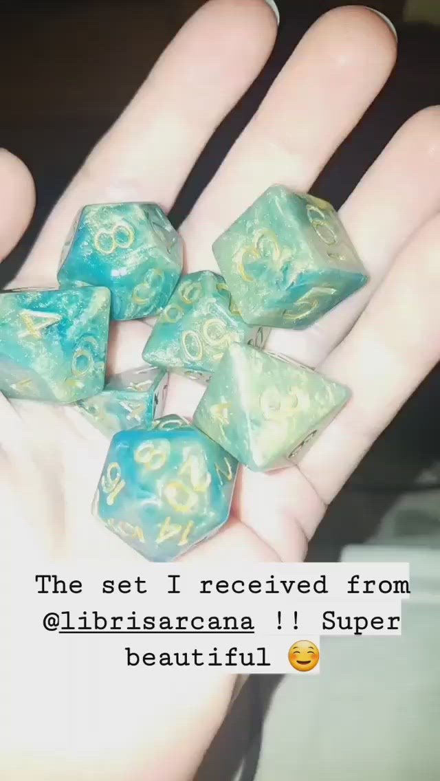 Customer video of Genesis, green and gold, 7 piece, resin DND dice set held in palm of hand.