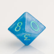 Infinite, cloudy blue dice with glittery inclusions and teal numbering. D10 on white background.