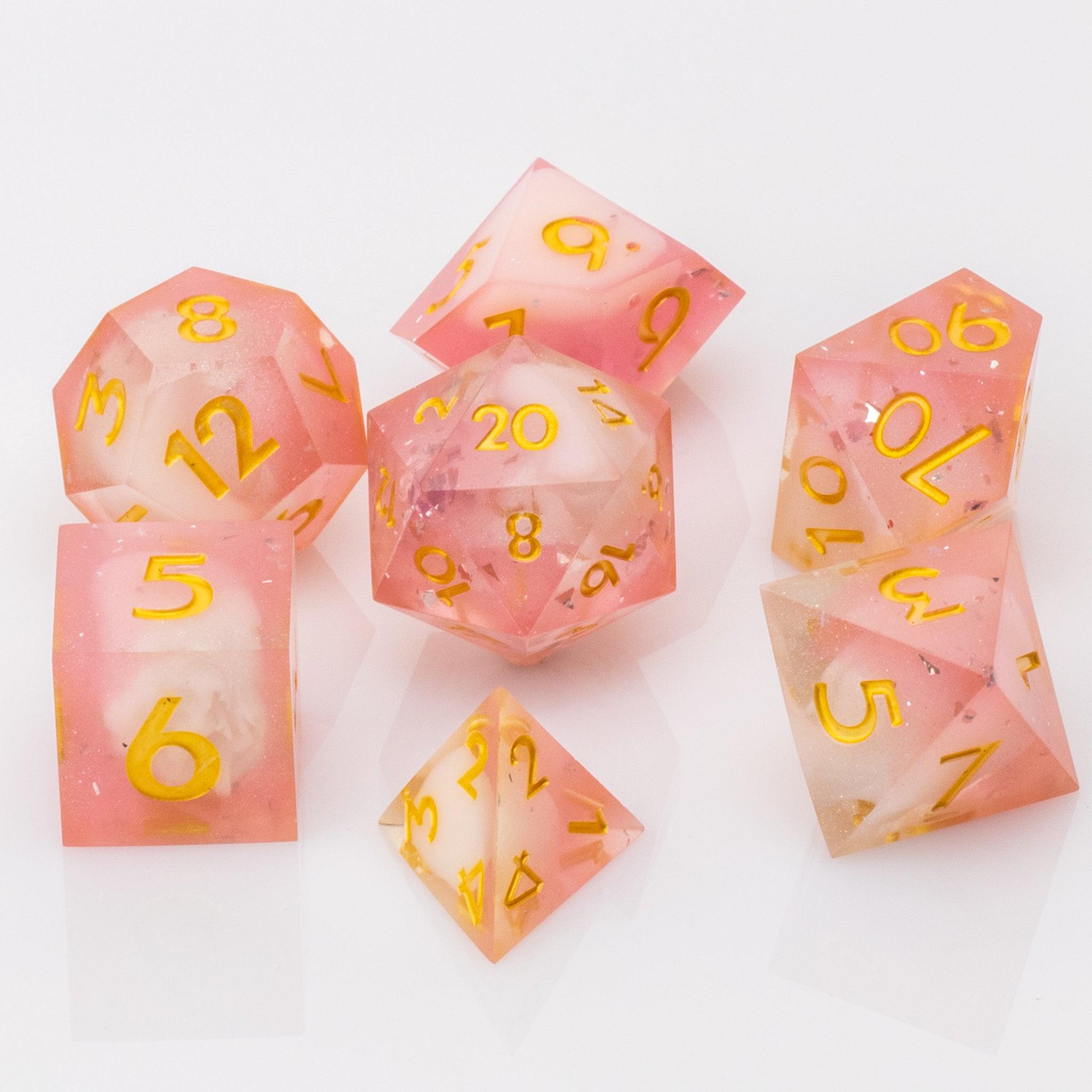 Lavendar Haze, pink and white handmade DND dice set on a white background.