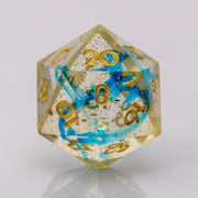 Moonlight, gold and blue handmade RPG dice D20 on a white background.