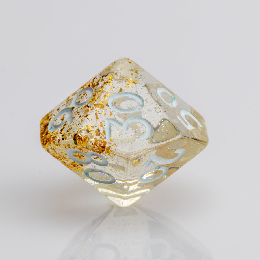 Myst--Translucent DND dice with layered gold flake inclusions. D00 on white background.
