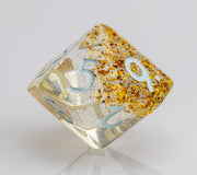 Myst--Translucent DND dice with layered gold flake inclusions. D10 on white background.