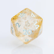 Myst--Translucent DND dice with layered gold flake inclusions. D20 on white background.