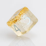 Myst--Translucent DND dice with layered gold flake inclusions. D6 on white background.