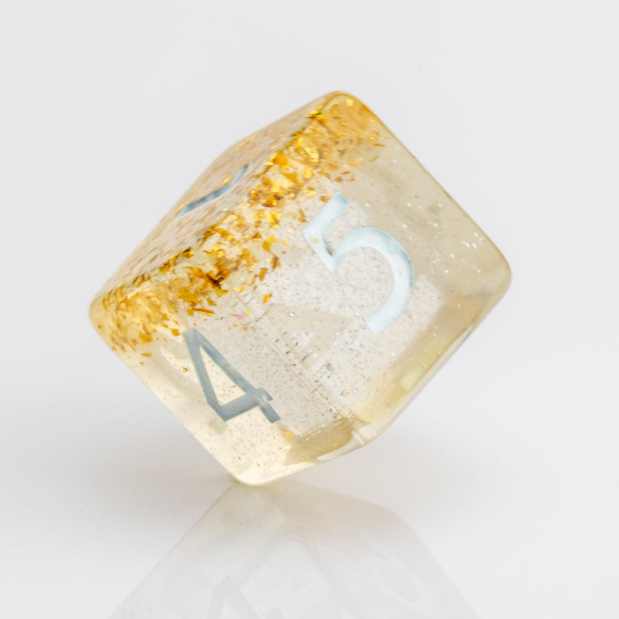 Myst--Translucent DND dice with layered gold flake inclusions. D6 on white background.