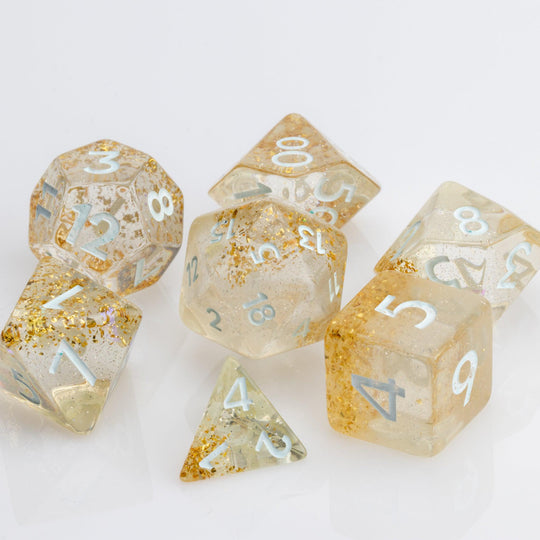 Myst--Translucent DND dice with layered gold flake inclusions. 7 piece DND dice set on white background.