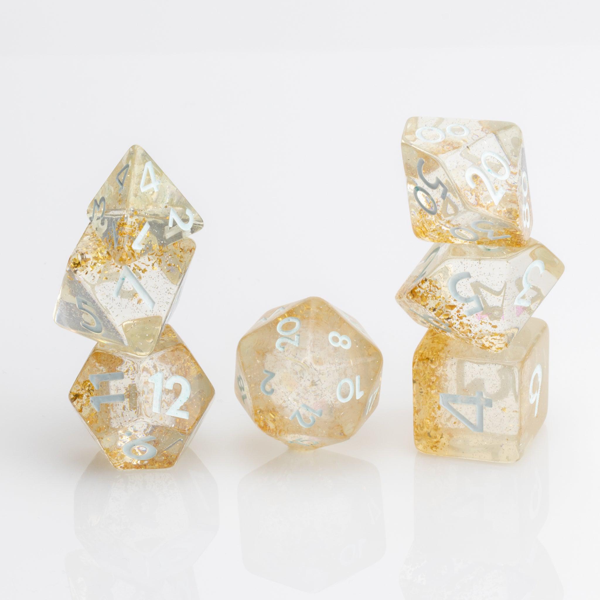 Myst--Translucent DND dice with layered gold flake inclusions. 7 piece DND dice set stacked on white background.