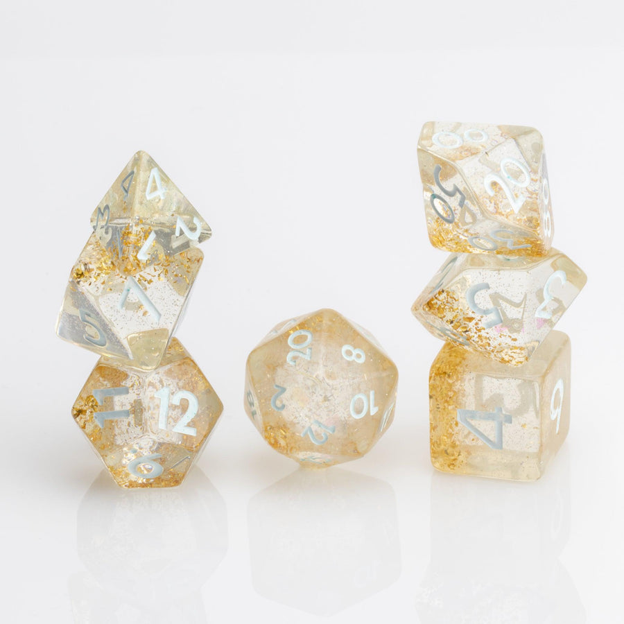 Myst--Translucent DND dice with layered gold flake inclusions. 7 piece DND dice set stacked on white background.