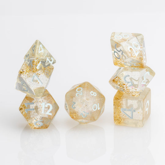 Myst--Translucent DND dice with layered gold flake inclusions. 7 piece DND dice set stacked on white background.