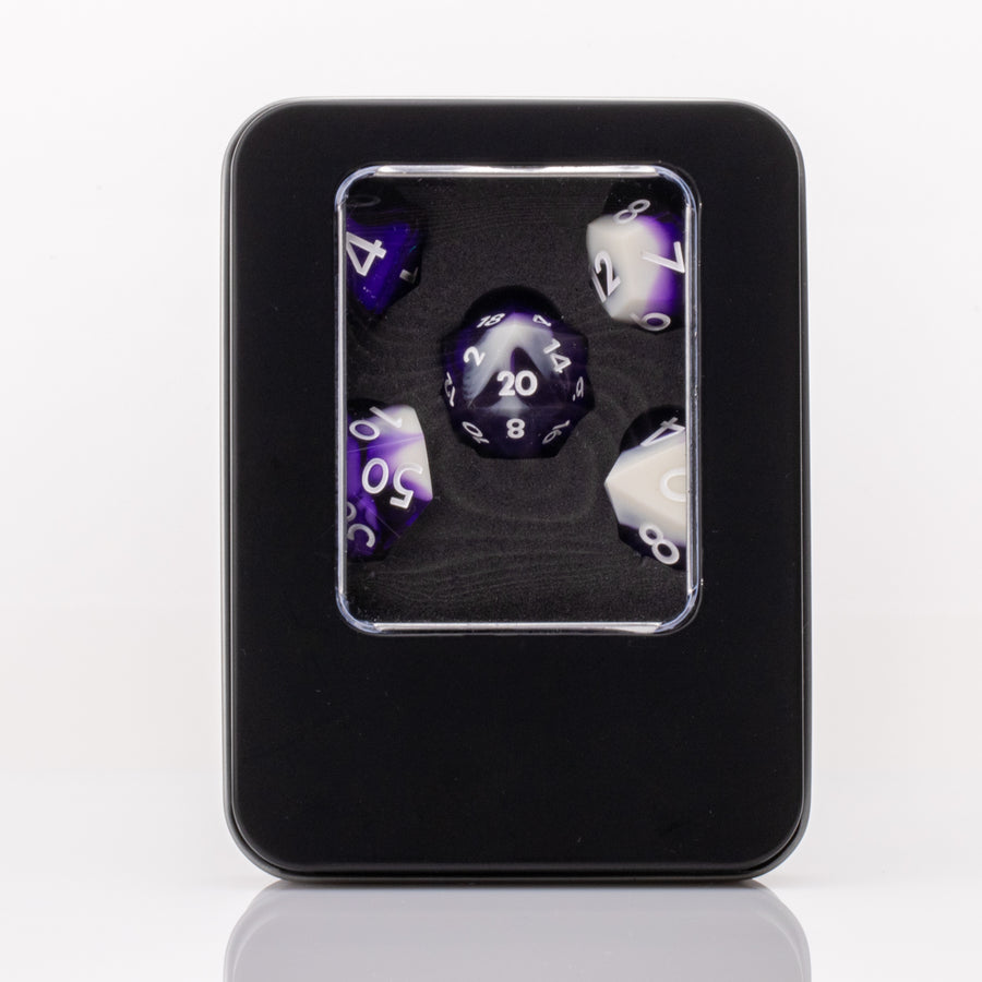 Nightfall, purple and white handmade DND dice set in decorative tin on a white background.