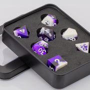 Nightfall, purple and white handmade DND dice set in decorative tin on a white background.
