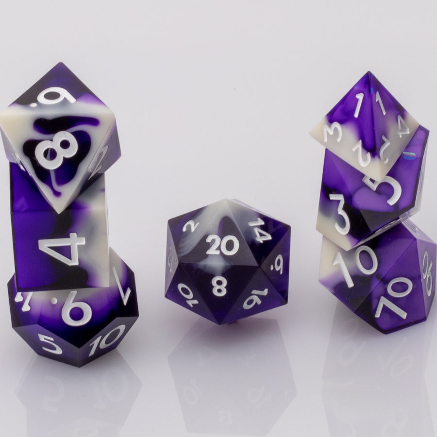 Nightfall, purple and white handmade DND dice set stacked on a white background.