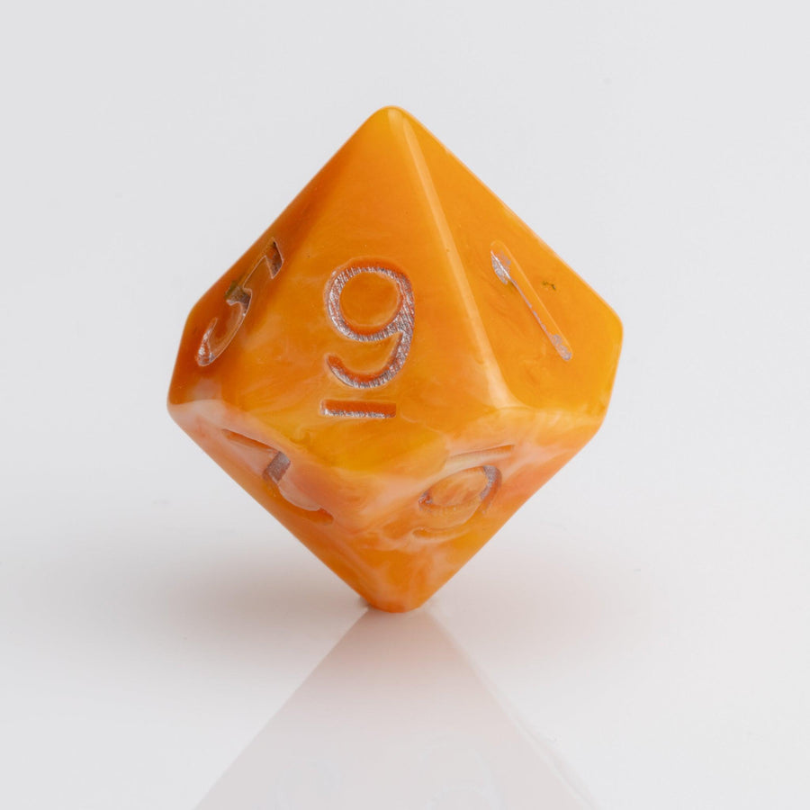 Orcana--Orange swirled RPG dice with gold metallic inking. D10 on white background.