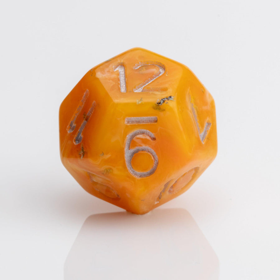 Orcana--Orange swirled RPG dice with gold metallic inking. D12 on white background.