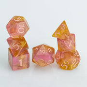 Pamplemousse, pink & orange gold 7 piece RPG dice set stacked on a white background.