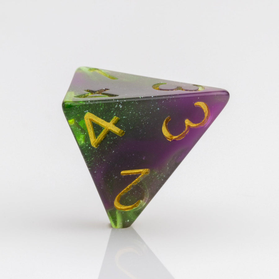 Perseid--Green and purple RPG dice with with swirled, glittery inclusions and gold metallic inking. D4 on white background.