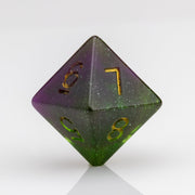 Perseid--Green and purple RPG dice with with swirled, glittery inclusions and gold metallic inking. D8 on white background.