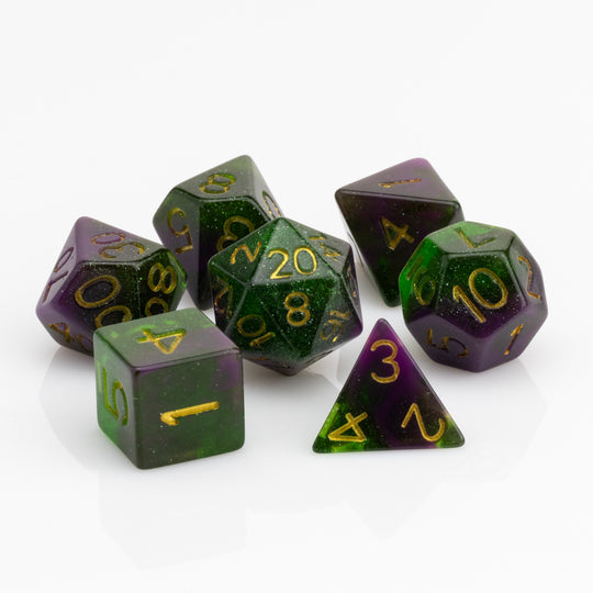 Perseid--Green and purple RPG dice with with swirled, glittery inclusions and gold metallic inking. 7 piece RPG dice set on white background.