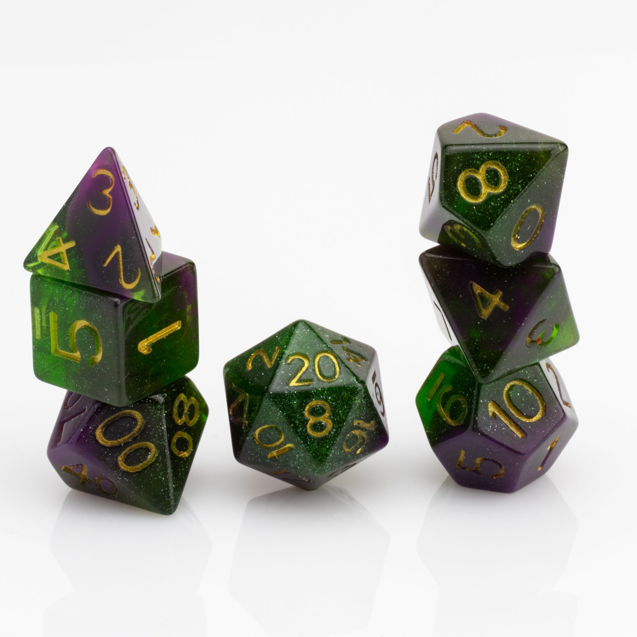 Perseid--Green and purple RPG dice with with swirled, glittery inclusions and gold metallic inking. 7 piece RPG dice set stacked on white background.