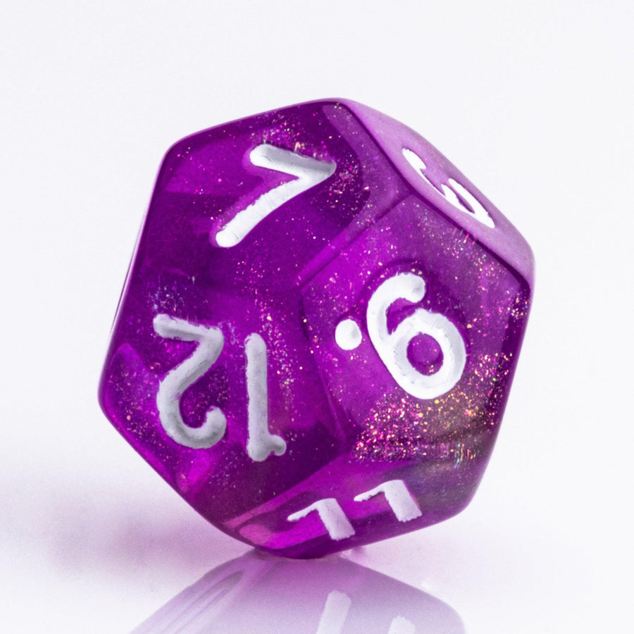 Rainbow Sherbet, purple and yellow gold translucent RPG dice with wite inking. 7 piece RPG dice set D12 on white background.
